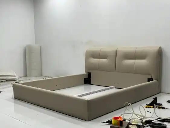 Beige bed frame structure during production phase
