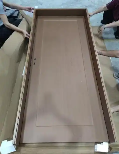 Factory workers carrying a large interior wood door