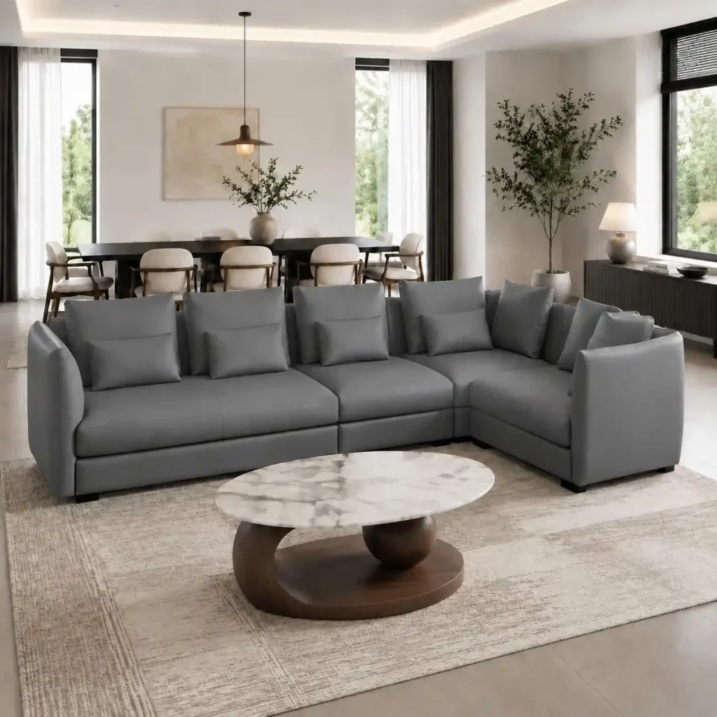 Open dining and living room with large grey sofa