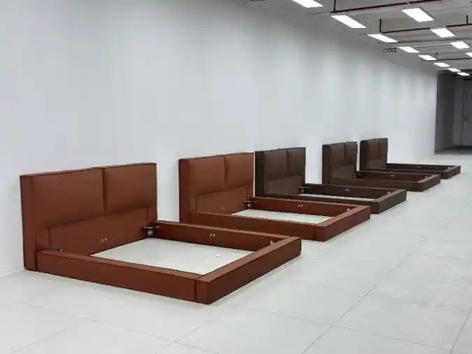 Row of wooden bed bases lined up in storage area